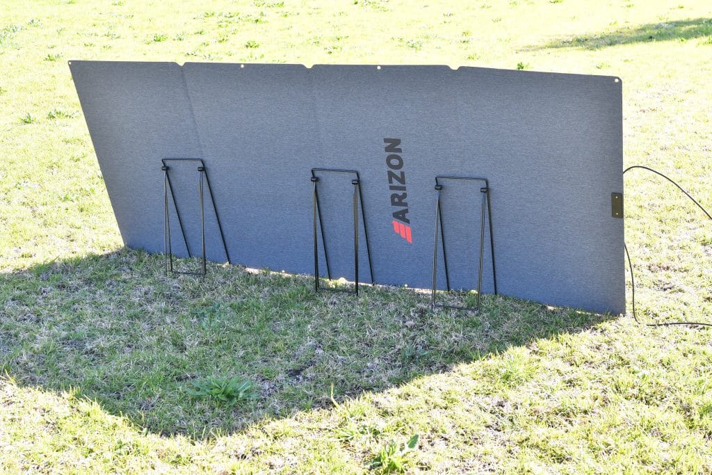 Rear view of the ModuFLEX 12/24V foldable panel on grass in bright sun