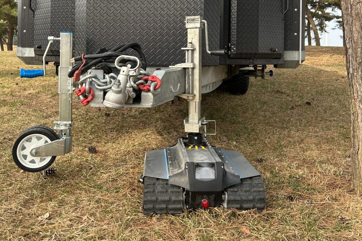 Close up of the All Terrain TK45 caravan mover on dry grass attached to a caravan a-frame 
