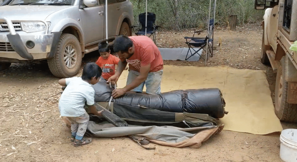 family packs up their double swag at Eliot Falls, showing the minimal gear needed for tent camping that will fit in a caravan when you go on tour. 