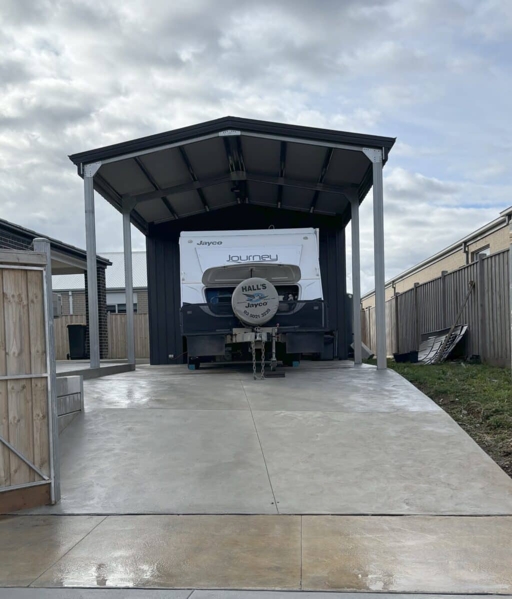 A Jayco pop-top parked in a custom size garage designed for housing a caravan. Note room above to allow for a full height van later on