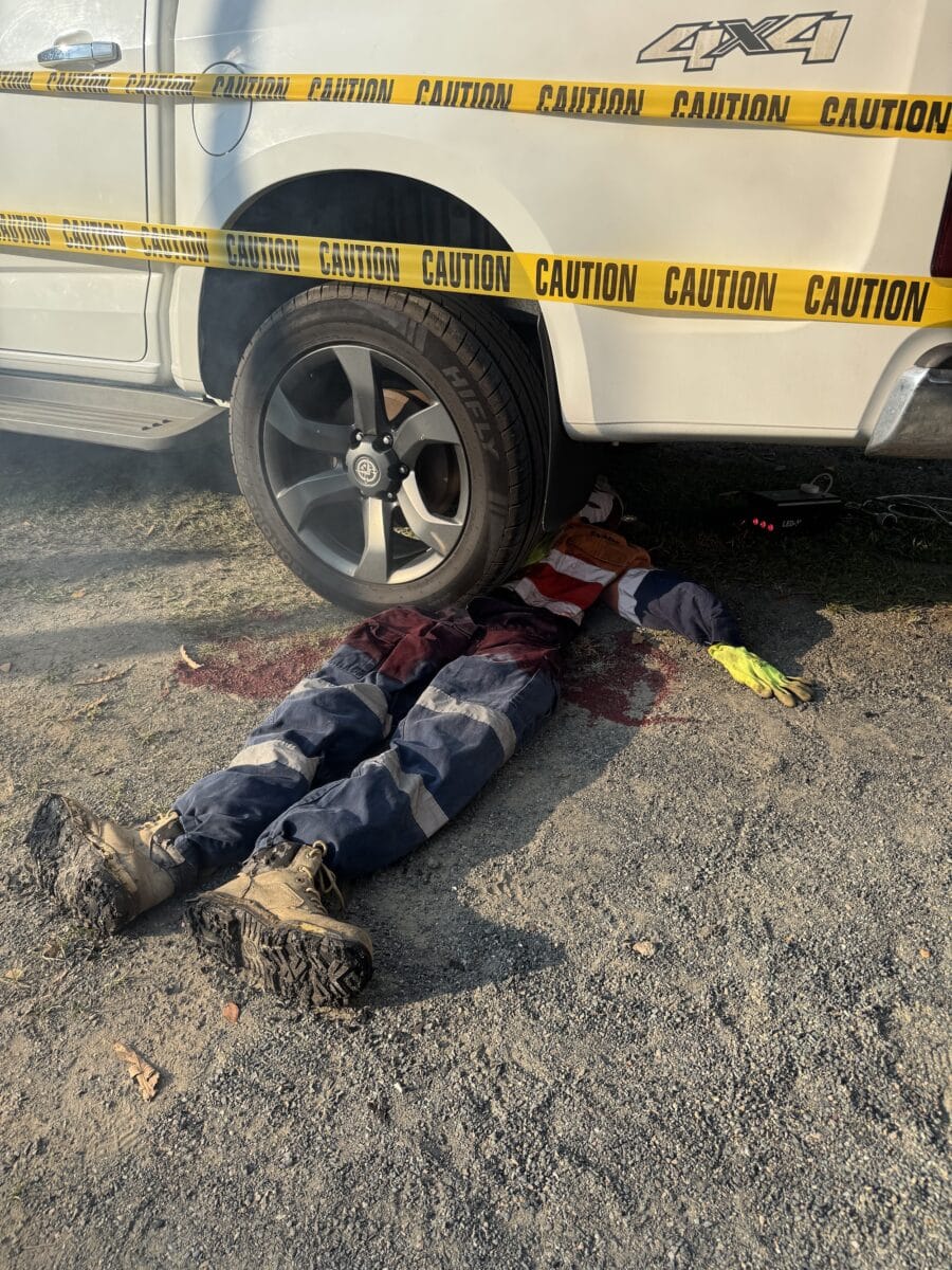 caution tape plasted across this van that has dummy under the wheel as a scary prop at the Camp and sCare fundraising event at the BIG4 Whitsunday Resort