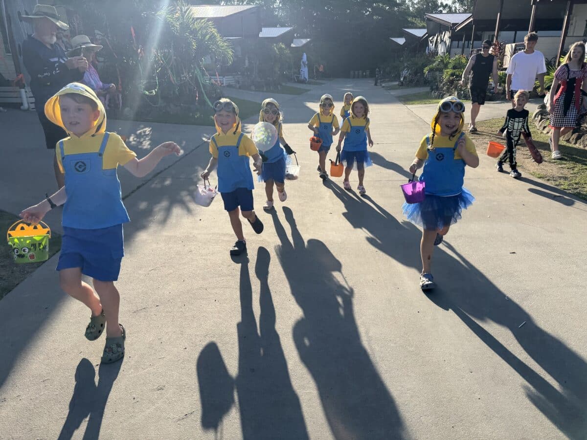 6 little 'minions' brandishing trick or treat baskets trick or treating at the BIG4 Whitsunday Resort