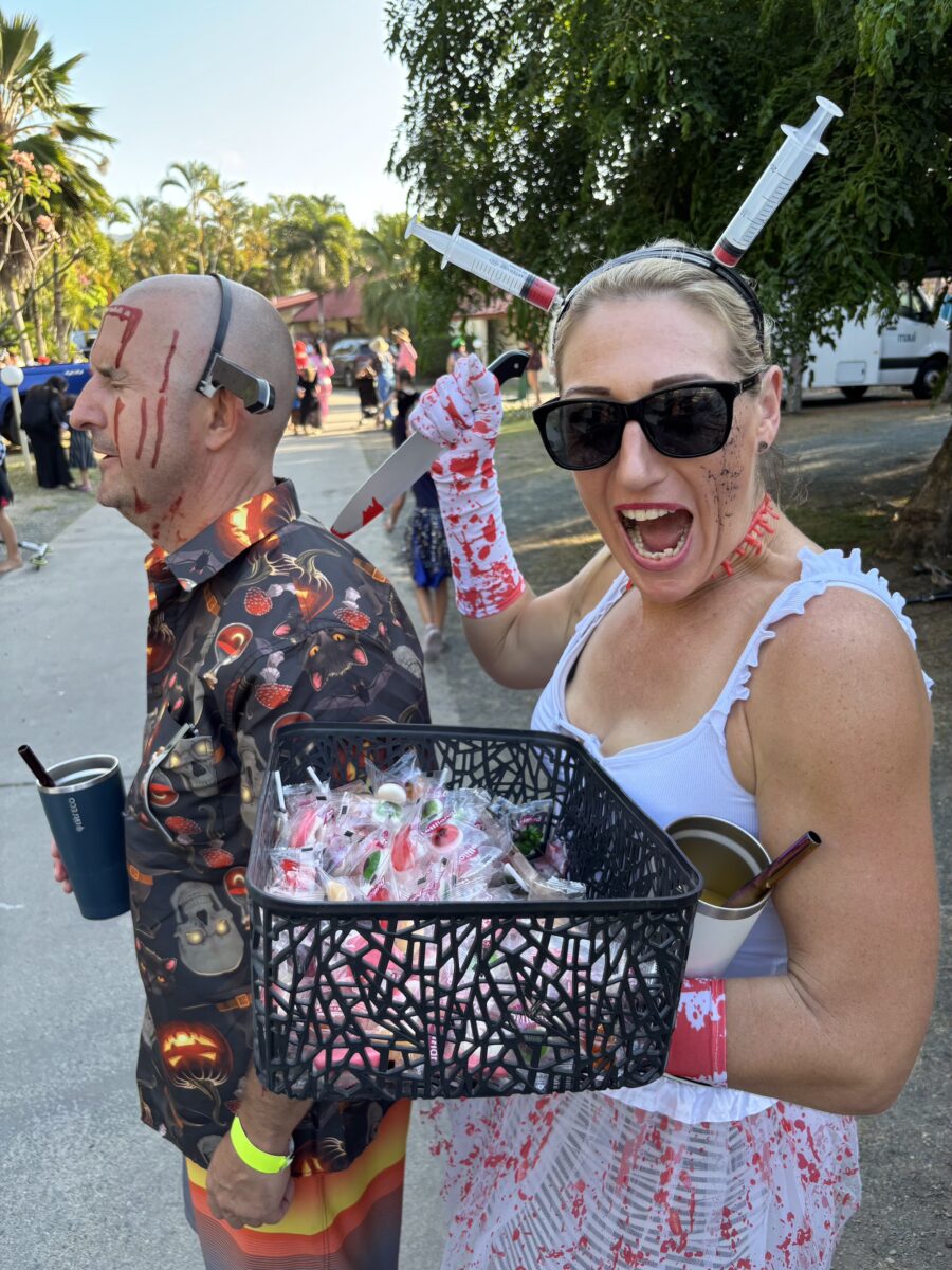 a women, with needle props holds a pretend knife into her 'angst-ridden' partner. All in good fun, raising funds at the BIG4 Whitsunday Resorts Camp and sCare event