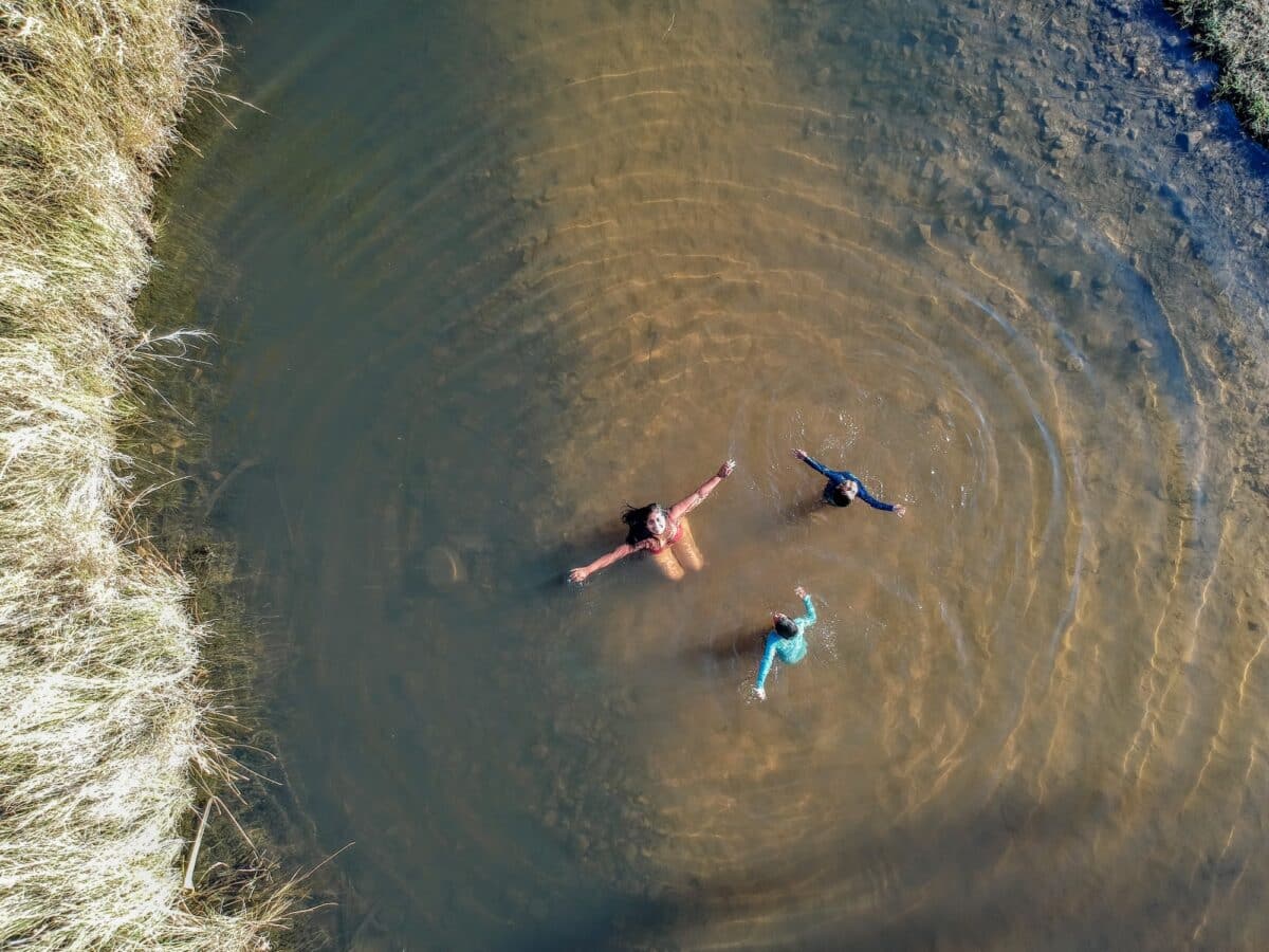 Aerial shot showing a women and two children enjoy the gorge at Wuggubun Aboriginal Community Campground