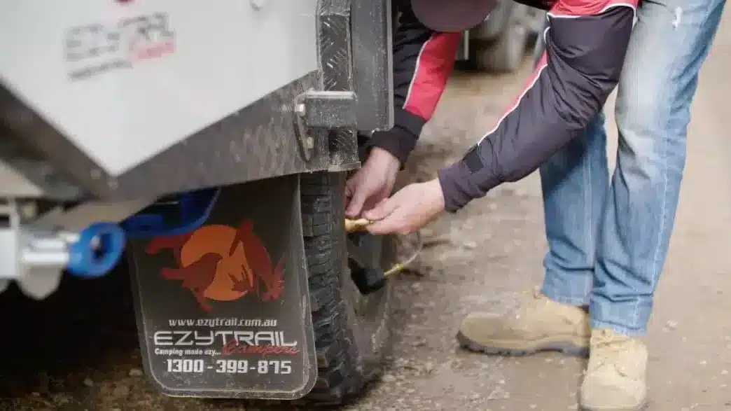 checking tyre pressure on ezytrail camper off road camper trailer