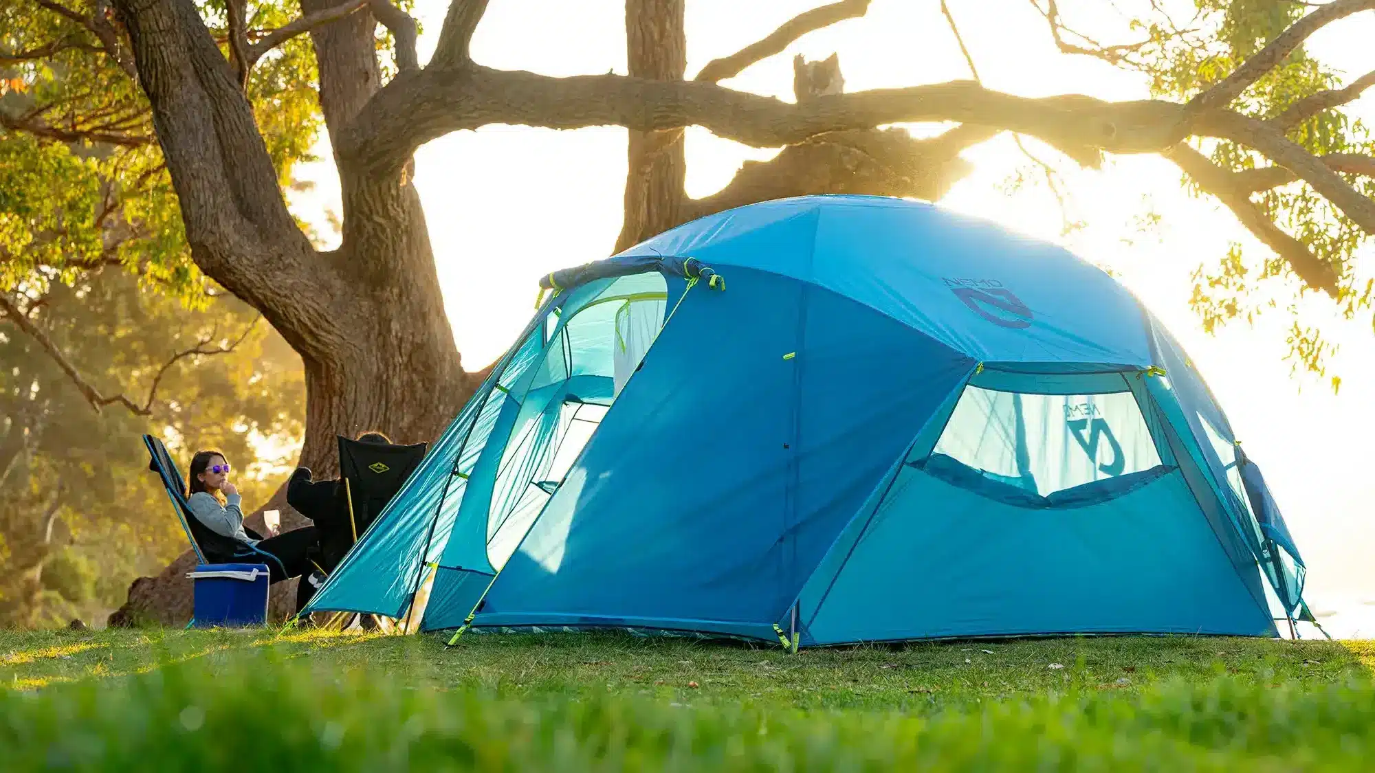 blue tent with sun backdrop under big tree lifestyle