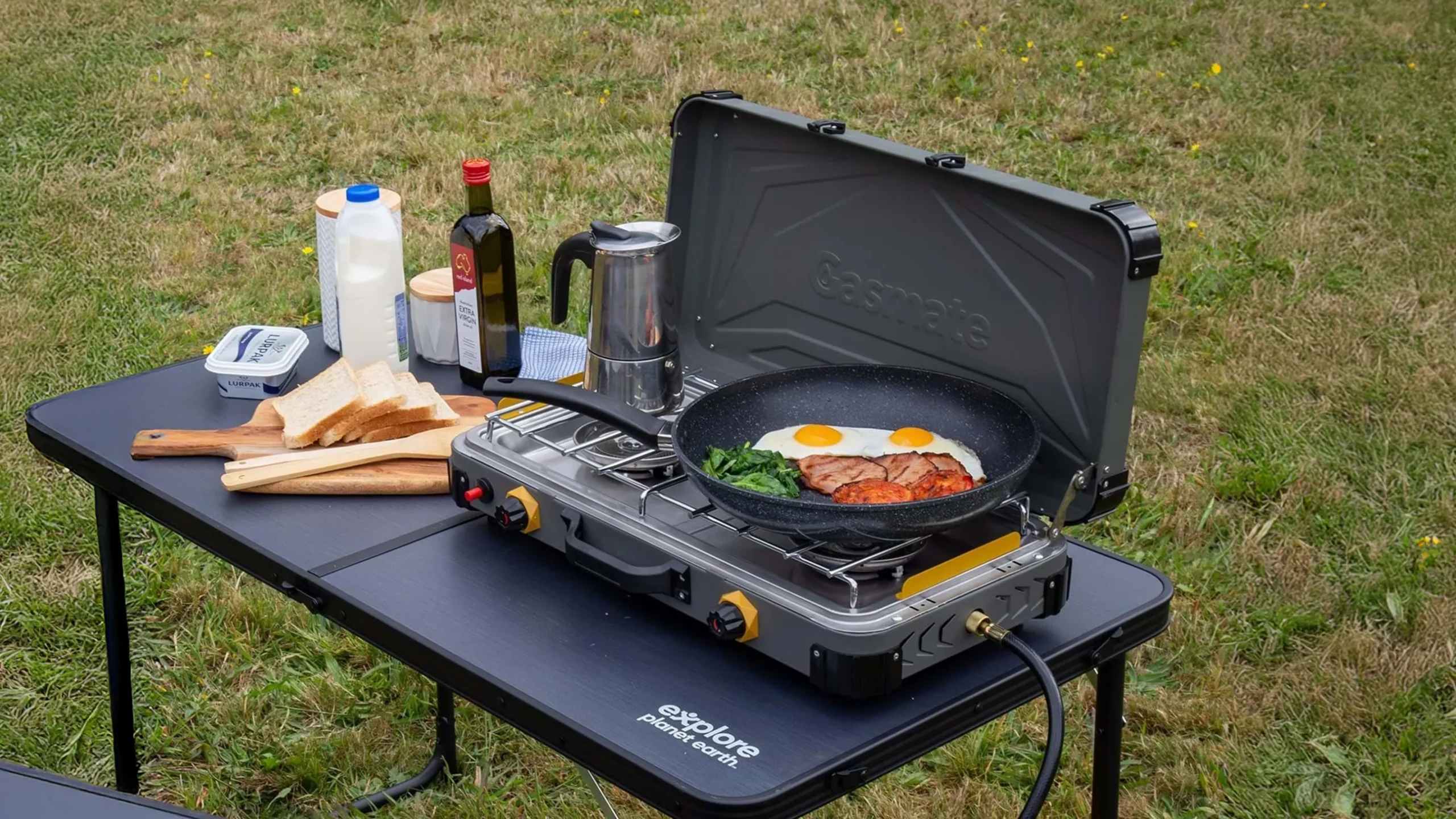 two burner gas stone cooking food and boiling water on camp table