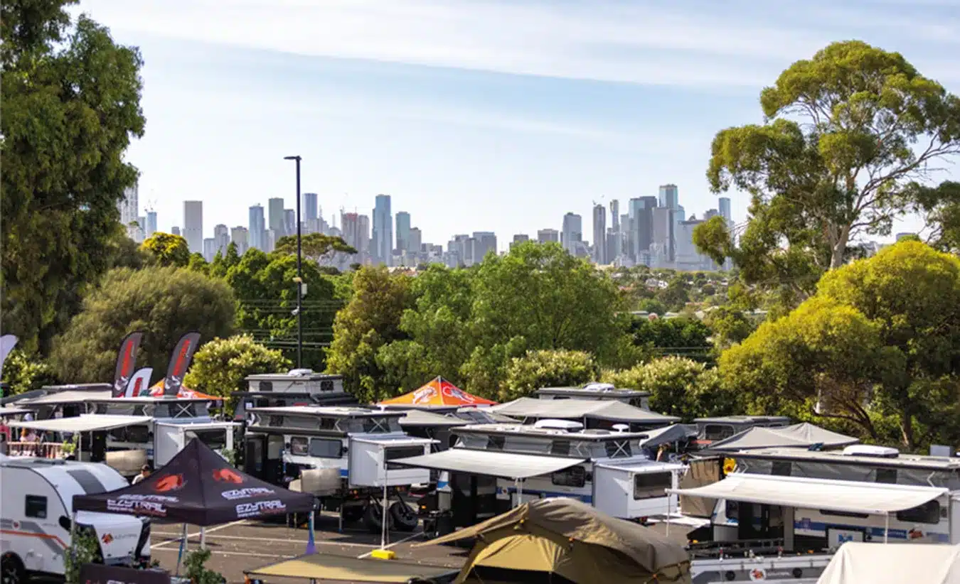 Caravans on display at the Melbourne Caravan Supershow with city skyline in the background