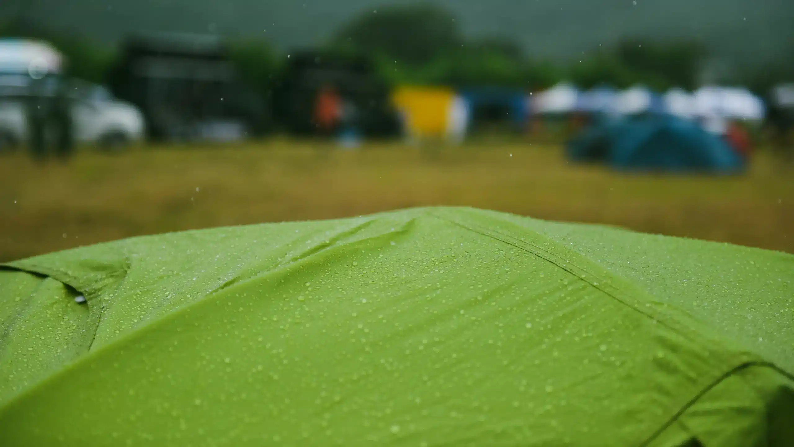 green tent with rain on it close up cinematic vibe