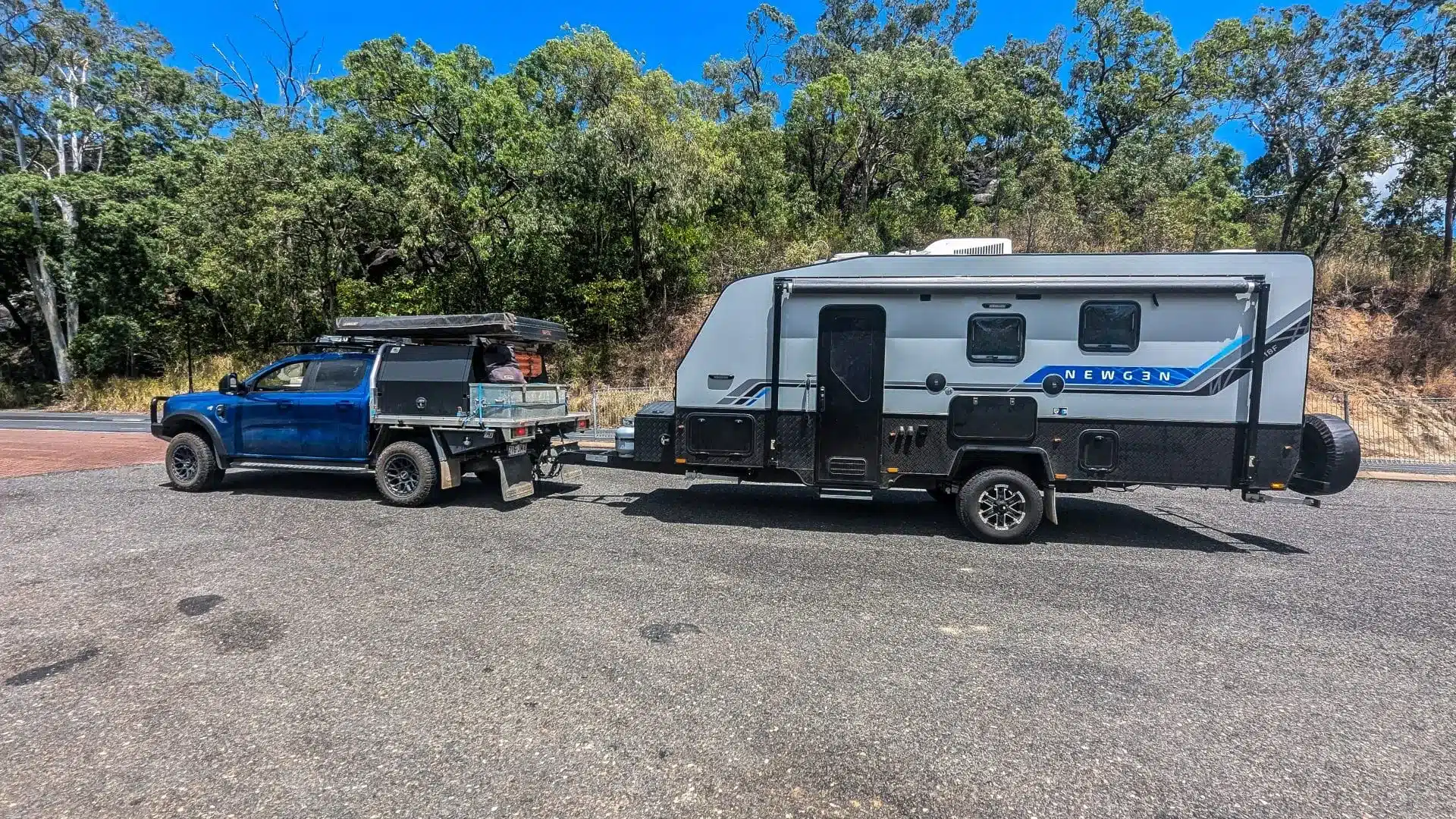 Dual cab ute towing a caravan on the roadside showing a full towing setup