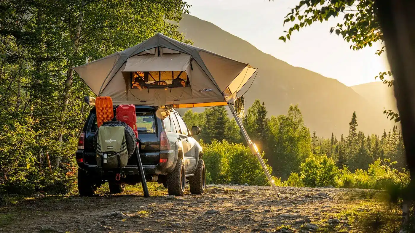 4WD with rooftop tent set up at remote off-grid campsite during sunset
